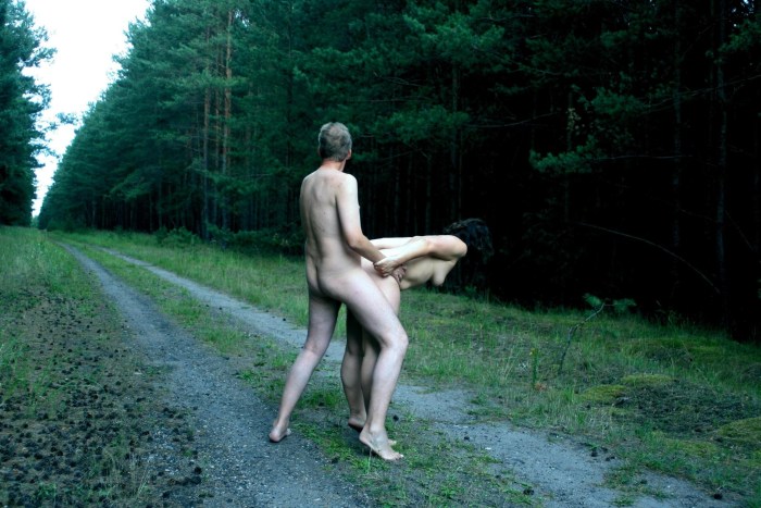 Naked men and women in the forest