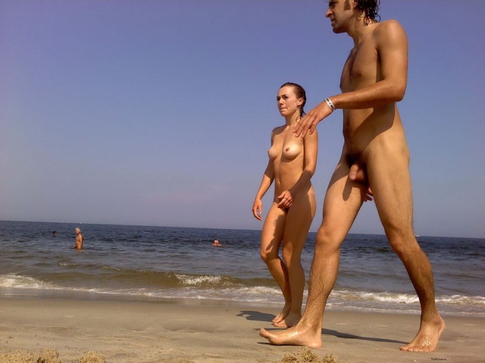 Naked men and women on a nudist beach