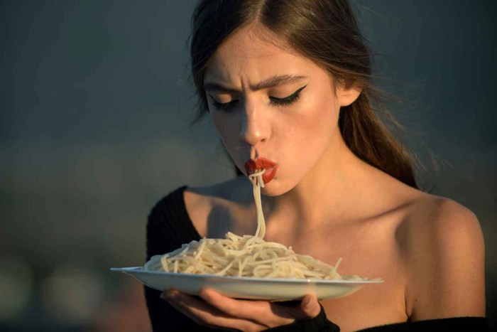 The girl eats pasta
