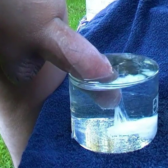 A naked man sits on a bottle