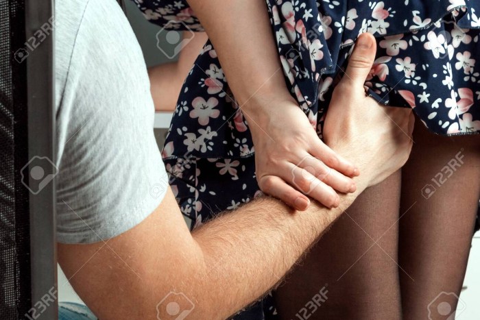 A man sneezes in an elbow