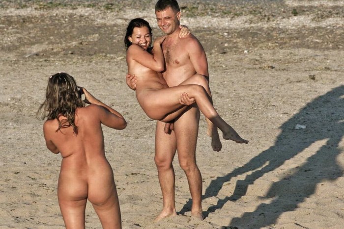 Naked men and women on the beach