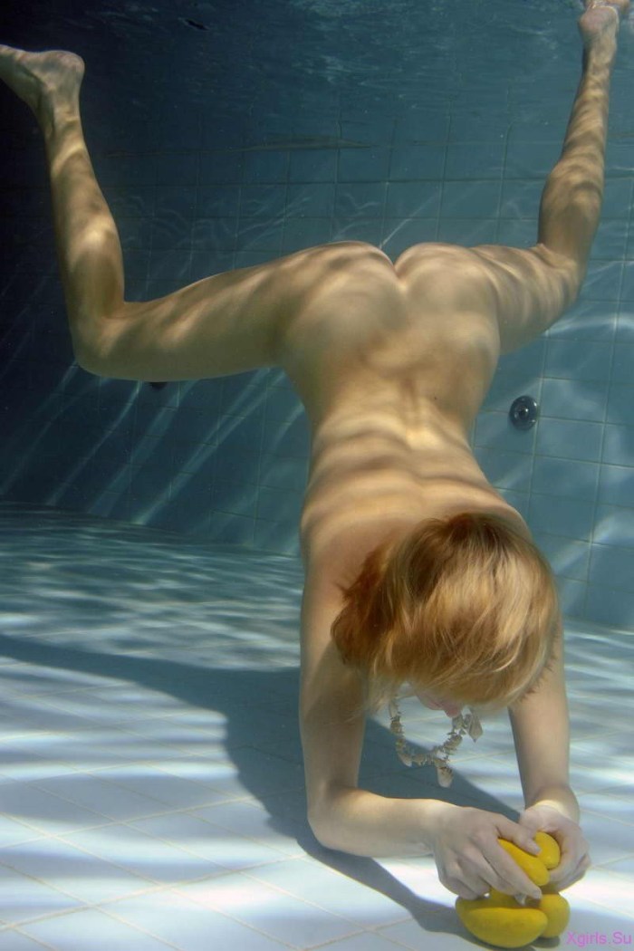 Naked women swim underwater