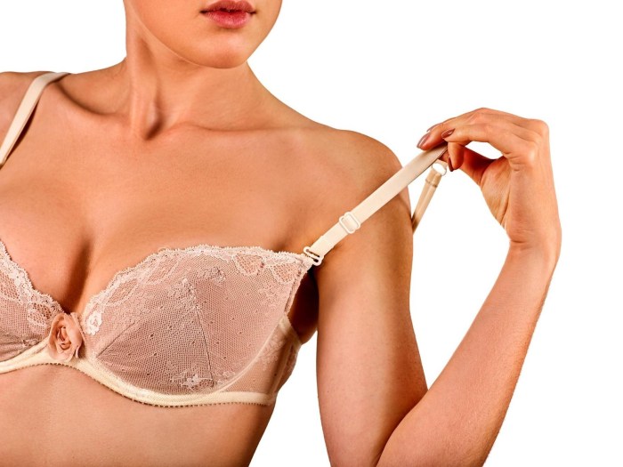 Women's bra in his hand