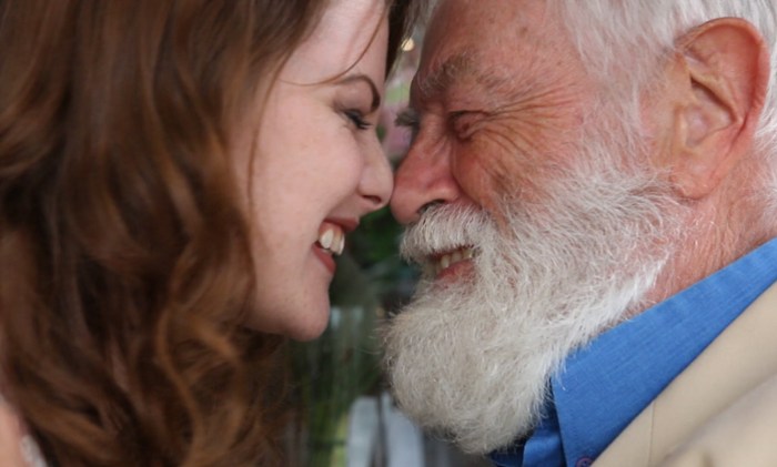 Grandfather combs her grandmother hair