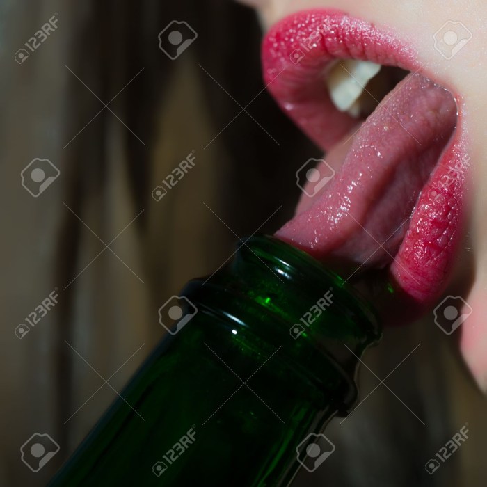 The girl licks the bottle