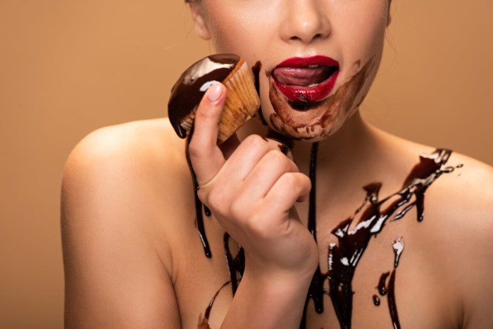 The woman licks chocolate