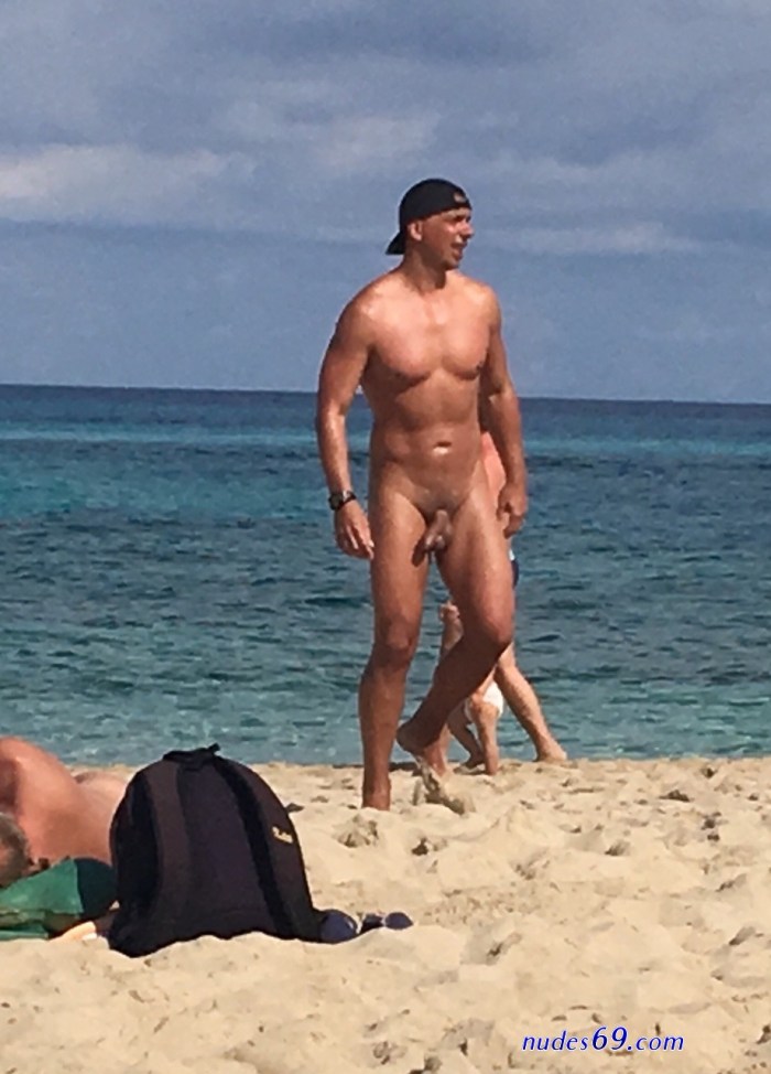 Naked Negro with a woman on the beach