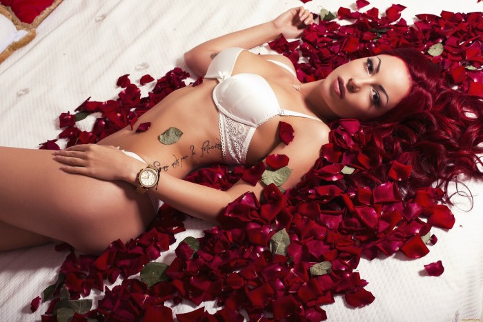 Girl lies in rose petals