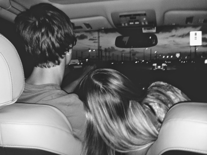 Blonde with guys in the car hug
