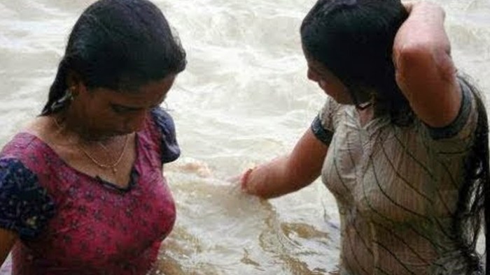 Indian women bathe
