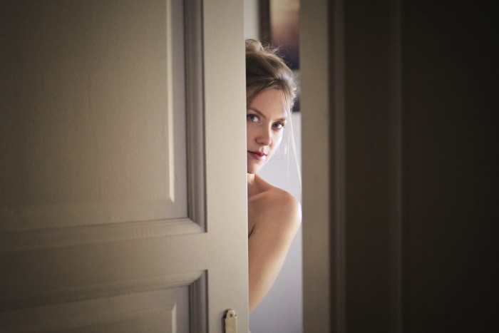 The woman opens the door