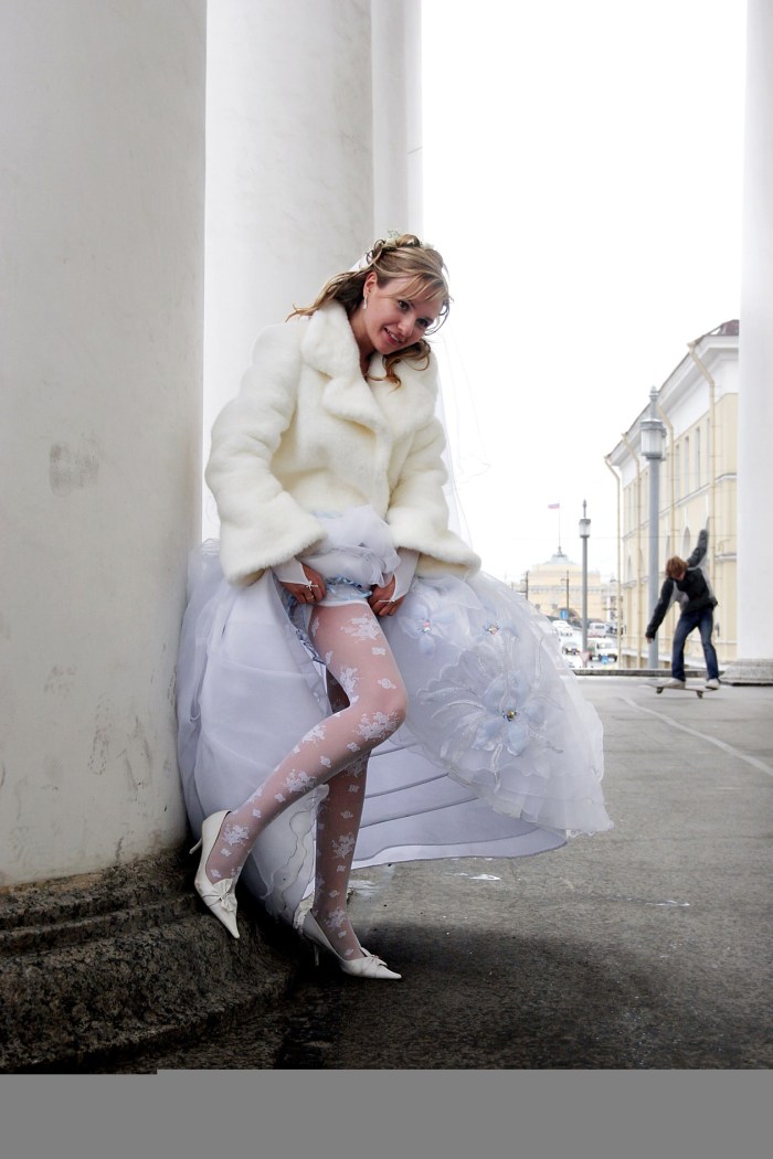 The bride sucks in a dress