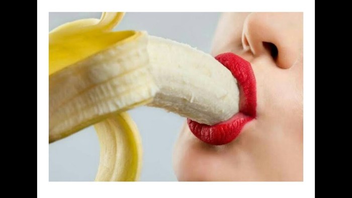 Girl with a banana in her mouth