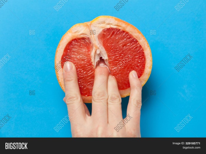 Grapefruit in the section with fingers