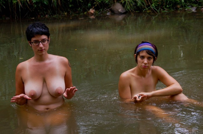 Naked women bathe in the river