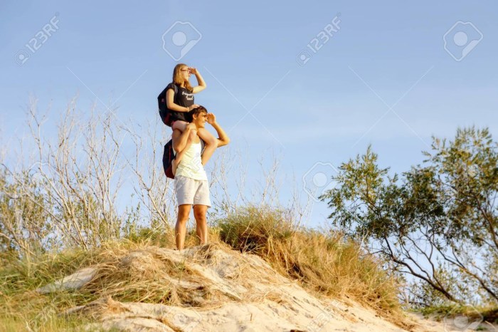 Girl sits on a man's neck