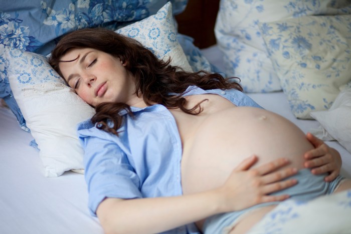 A pregnant woman is sleeping