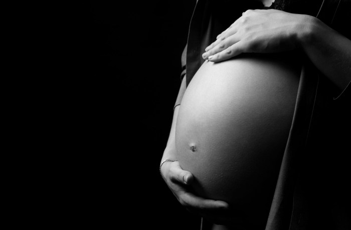 Pregnant woman on a black background