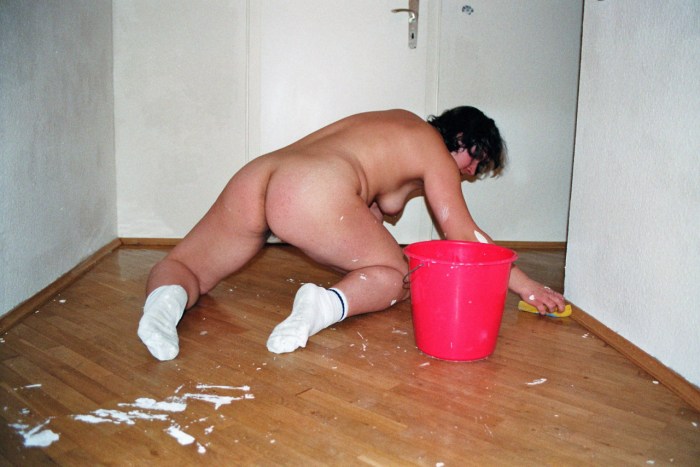 A naked woman is cleaning