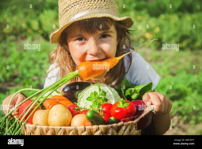 Girl and boy garden heat first vegetables