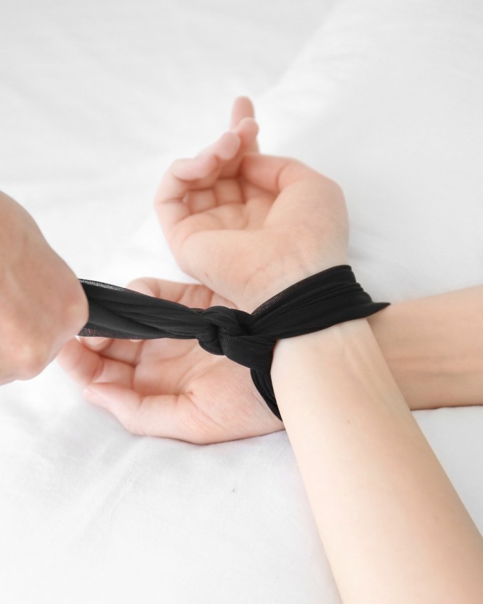 The man is chained to bed