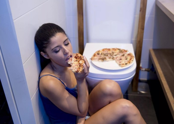 The girl eats from the toilet