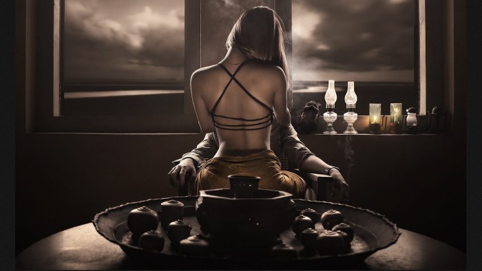 Girl sits on the table in the kitchen