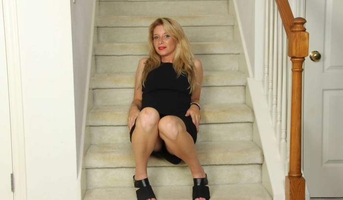 Girl sits on the steps between her legs