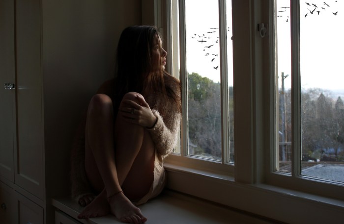 Girl sits on the windowsill