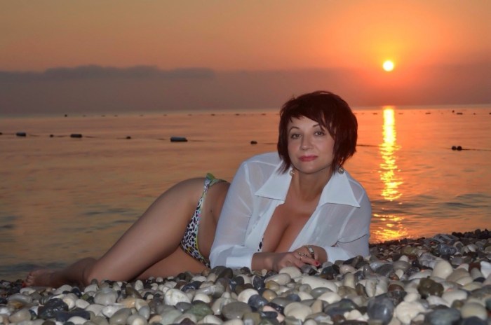 A man hugs a woman from the back