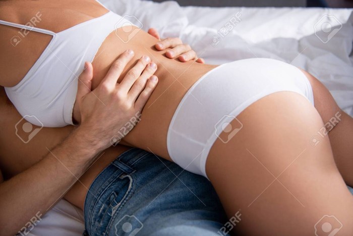 Naked woman sits on the side