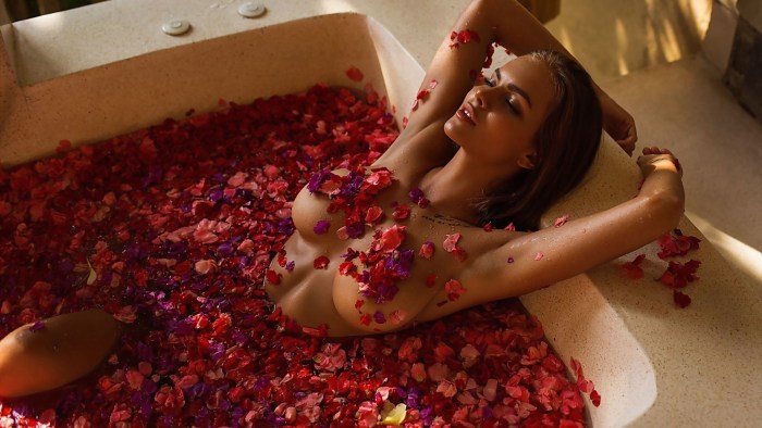 Girl in a bath with rose petals