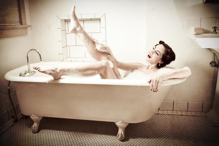 The girl lies in the bath