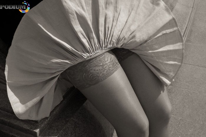 Under the hem of the dress of stockings