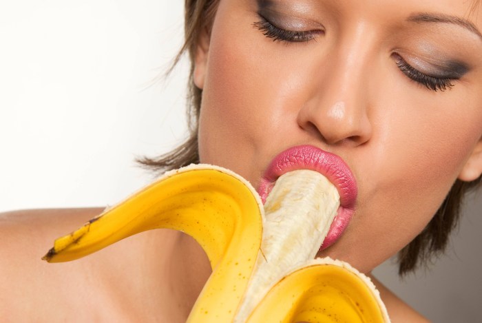 Girl with a banana in her mouth