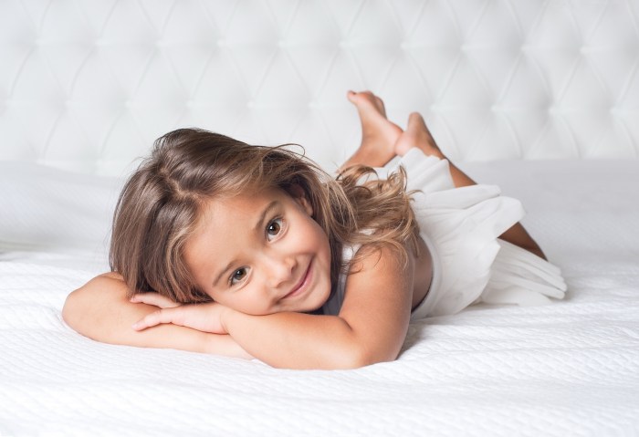 The child lies on the bed