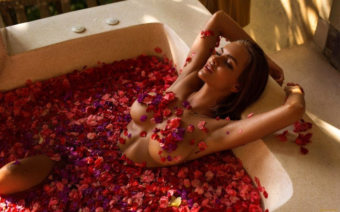 Girl in a bath with rose petals
