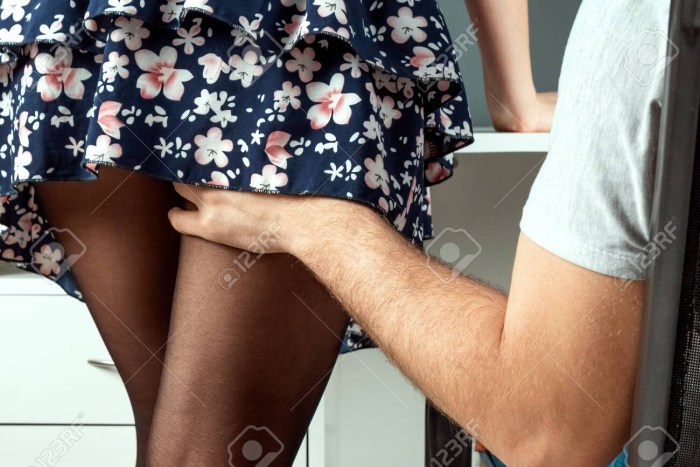 Photo of a girl with the hands of men under a skirt