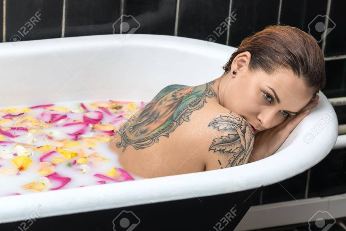 Naked mother in a bath in oil
