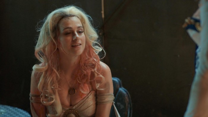 A naked blonde laughs