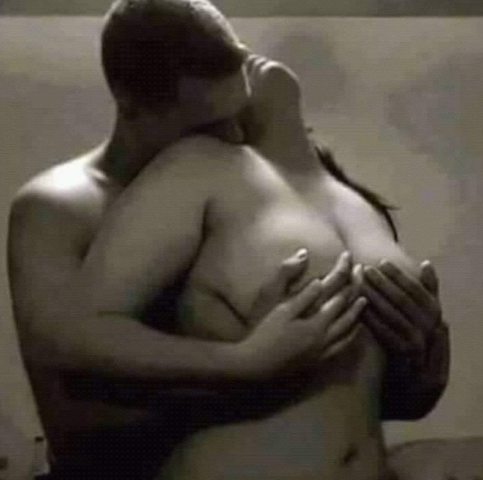 A naked man hugs a naked woman