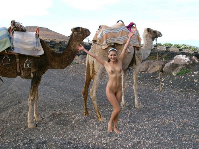 Naked with a camel in the desert