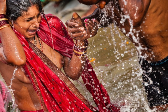 Indian women bathe