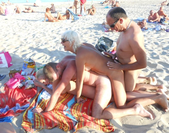 Swingers on a public beach
