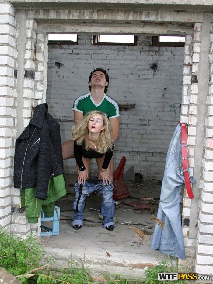 The girl undresses behind garages